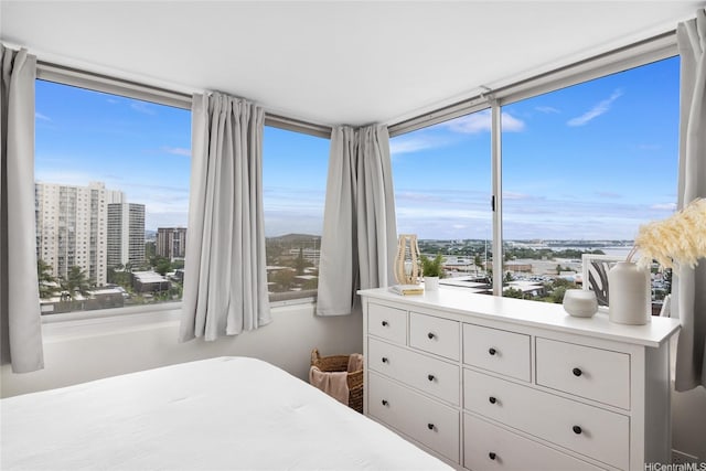 bedroom featuring a city view