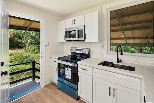 2315 California Ave Unit B, Wahiawa, HI 96786 - kitchen featuring a sink, appliances with stainless steel finishes, a wealth of natural light, and light countertops
