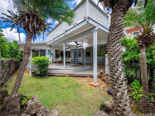 rear view of house featuring a lawn