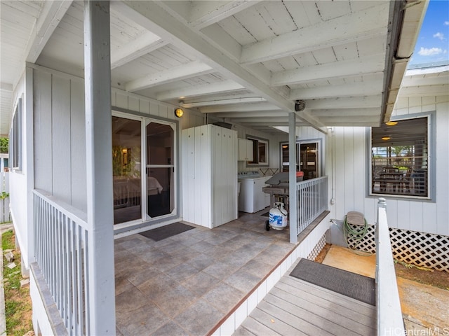 view of patio featuring washing machine and clothes dryer