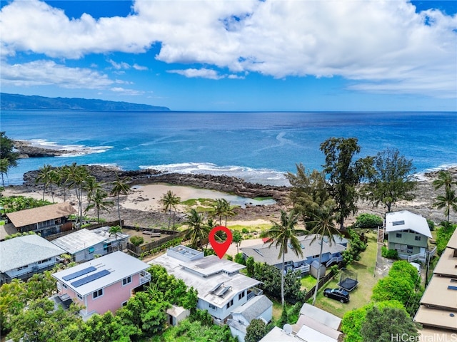 drone / aerial view featuring a water view and a beach view