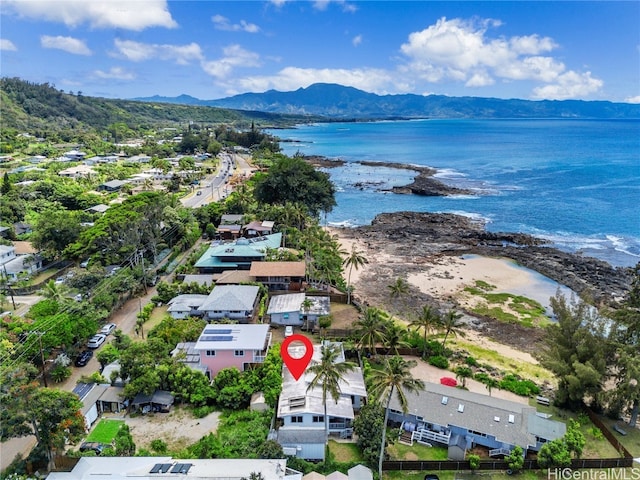 birds eye view of property with a water and mountain view