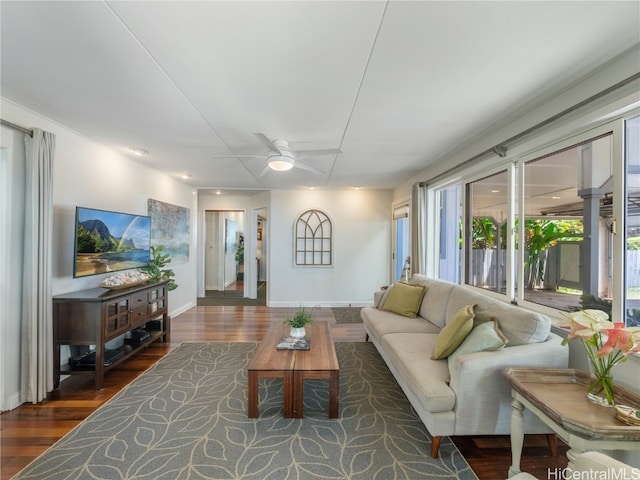 living room featuring dark wood-type flooring, plenty of natural light, and ceiling fan