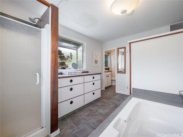 bathroom with vanity and shower with separate bathtub