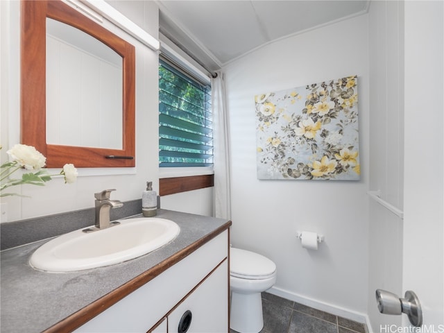 bathroom with vanity, toilet, and tile patterned floors