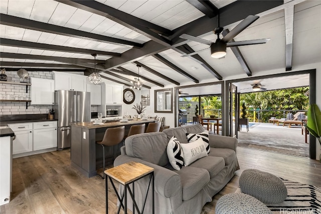 living room featuring dark hardwood / wood-style floors and lofted ceiling with beams