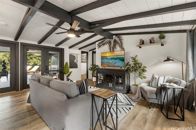 living room with french doors, lofted ceiling with beams, hardwood / wood-style flooring, and ceiling fan