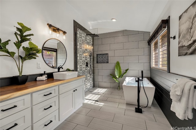 bathroom featuring vanity, tile walls, lofted ceiling, and shower with separate bathtub