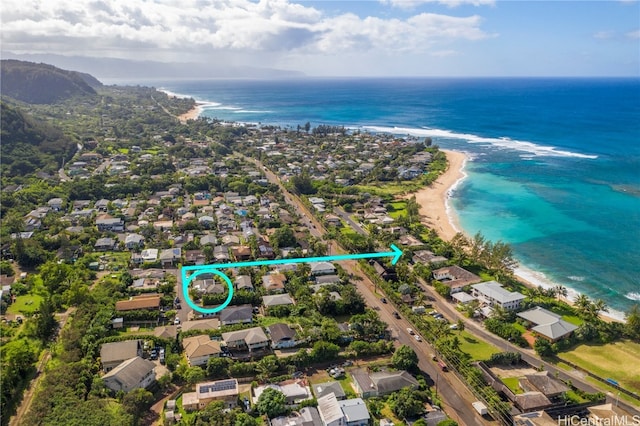 bird's eye view with a water view and a beach view