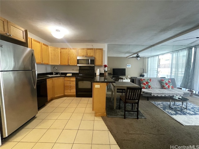 kitchen with kitchen peninsula, light tile patterned floors, a textured ceiling, black appliances, and sink