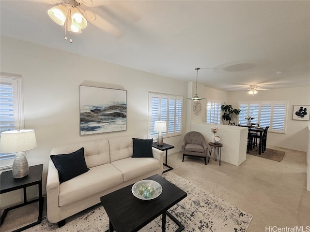 carpeted living room with plenty of natural light and ceiling fan