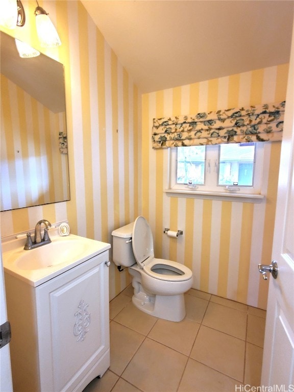 bathroom with vanity, toilet, and tile patterned floors