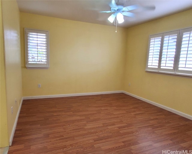 spare room featuring dark hardwood / wood-style floors and ceiling fan