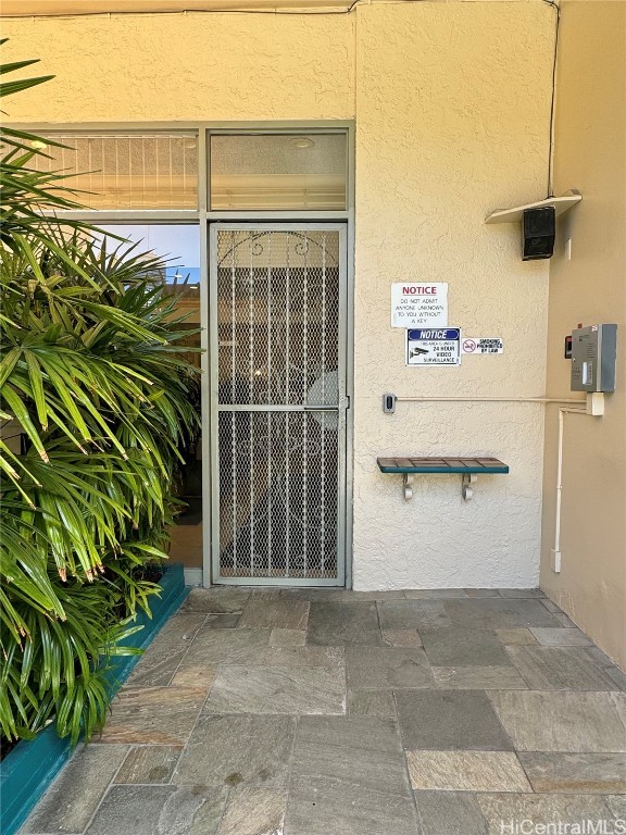 doorway to property with stucco siding