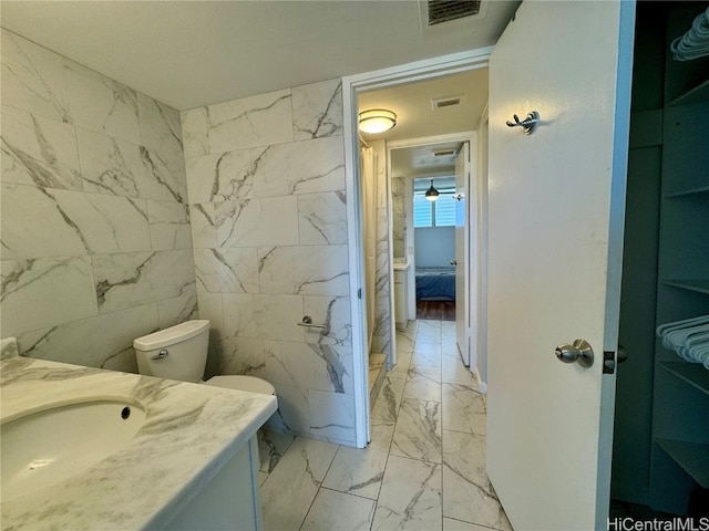 bathroom with vanity, visible vents, marble finish floor, and connected bathroom