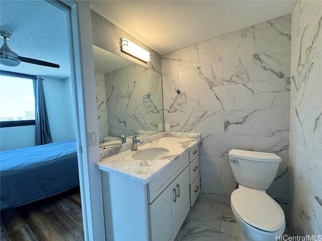 bathroom featuring marble finish floor, toilet, vanity, and connected bathroom