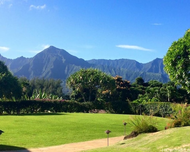 surrounding community with a lawn and a mountain view
