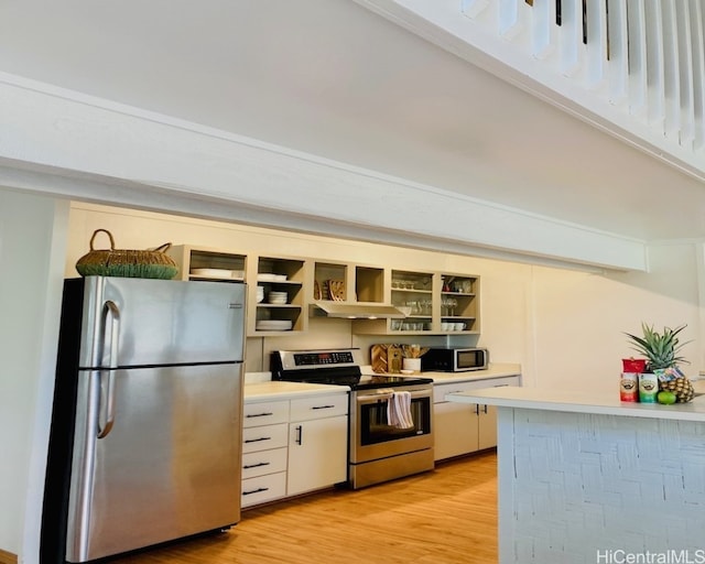 kitchen with light wood-type flooring, stainless steel appliances, and white cabinetry