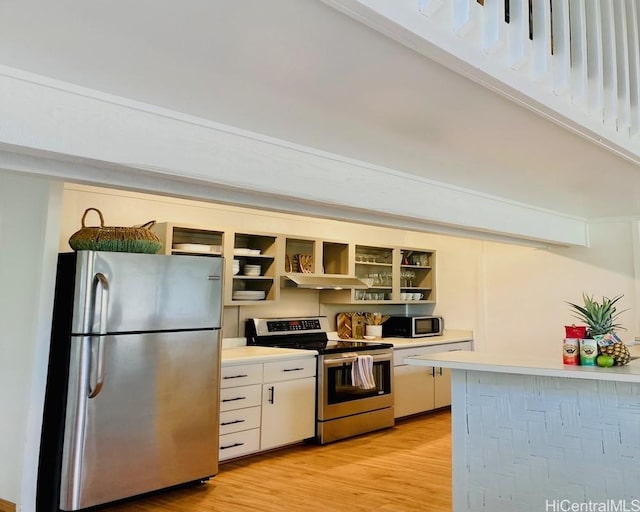 kitchen with appliances with stainless steel finishes, open shelves, light wood finished floors, and light countertops