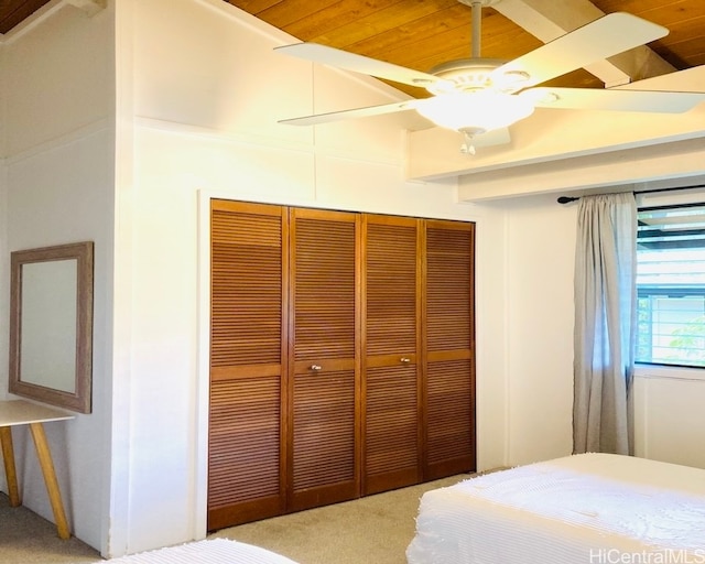 bedroom featuring ceiling fan, a closet, light colored carpet, and wooden ceiling