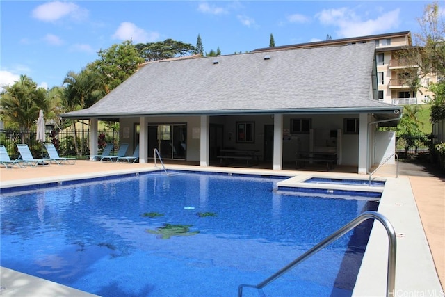 view of swimming pool featuring a community hot tub and a patio area