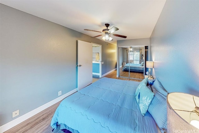 bedroom with hardwood / wood-style flooring, ceiling fan, and a closet