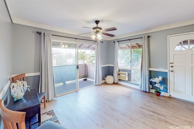 living area with ceiling fan, crown molding, and light hardwood / wood-style floors