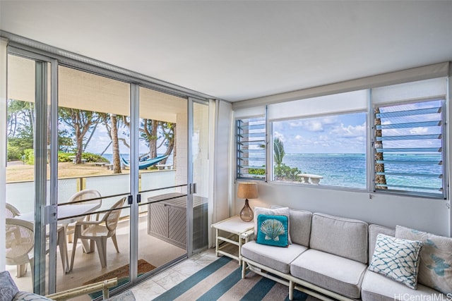 sunroom / solarium featuring a water view