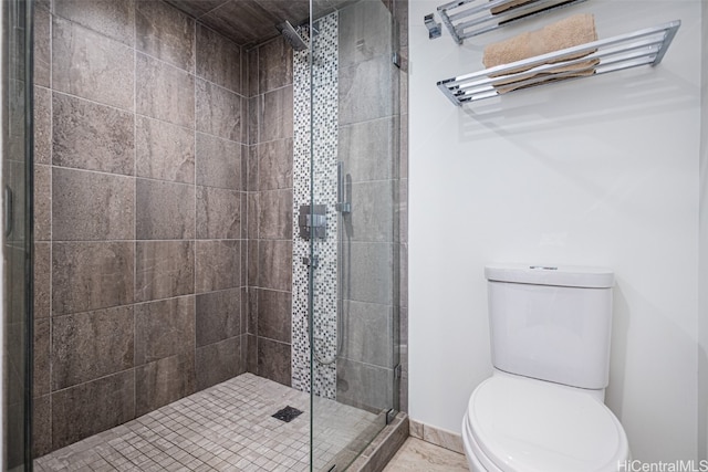 bathroom with toilet and an enclosed shower