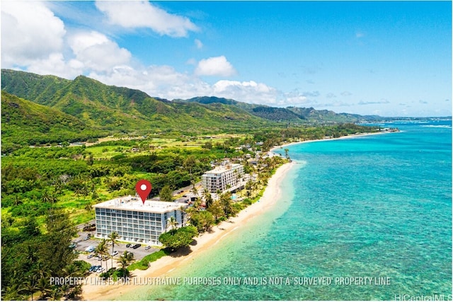 birds eye view of property with a water and mountain view and a beach view