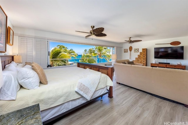 bedroom with ceiling fan and light wood-type flooring