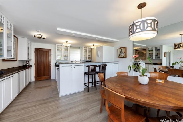 dining room with sink and light hardwood / wood-style floors