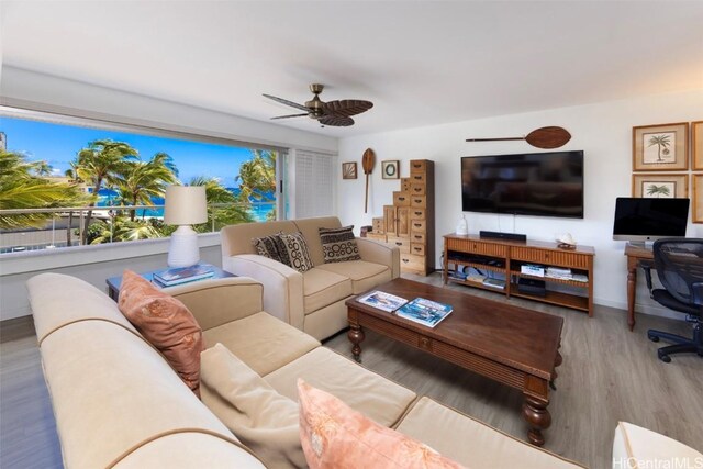 living room with ceiling fan and light hardwood / wood-style floors