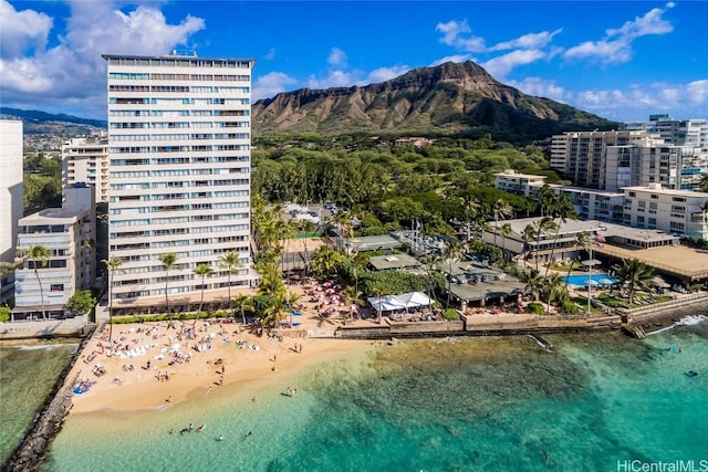 birds eye view of property with a water and mountain view and a view of the beach