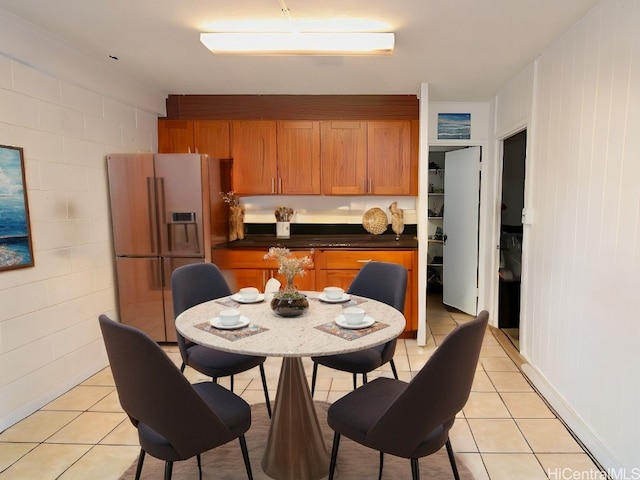 kitchen featuring white fridge with ice dispenser and light tile patterned floors