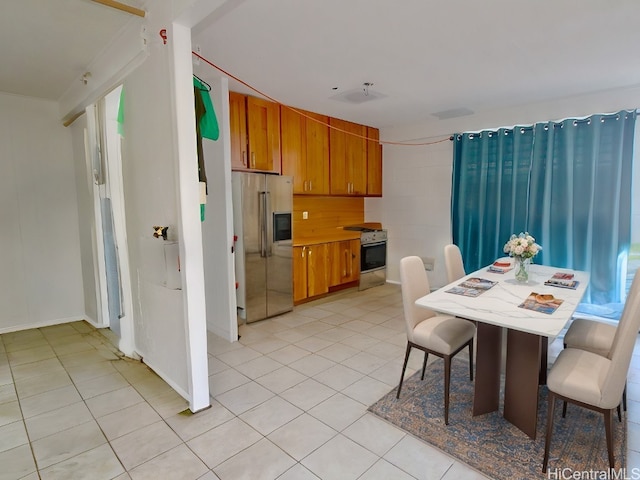 kitchen with light tile patterned flooring and stainless steel appliances