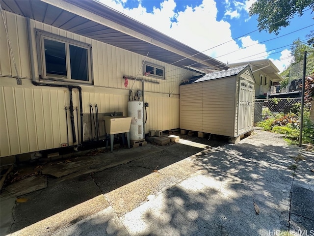 view of property exterior with a storage shed, electric water heater, and sink