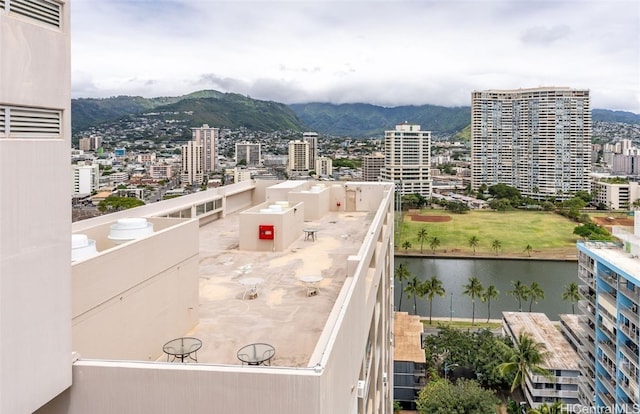 balcony featuring a water and mountain view