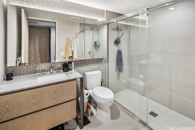 bathroom with backsplash, an enclosed shower, toilet, vanity, and tile patterned flooring