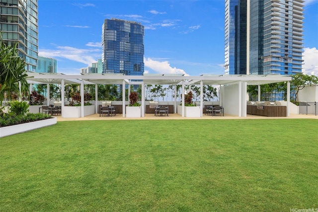 1000 Auahi St Unit 2506, Honolulu, HI 96814 - surrounding community featuring a pergola, outdoor dining area, a yard, and a patio area