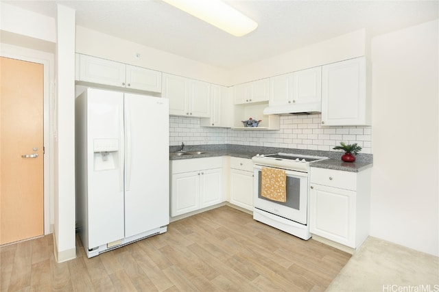 kitchen with sink, light wood-type flooring, white cabinets, white appliances, and tasteful backsplash