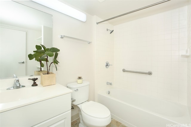 full bathroom featuring tiled shower / bath, vanity, and toilet