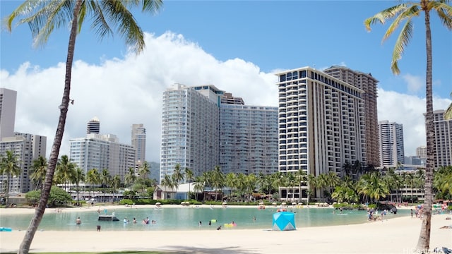 view of property featuring a water view and a beach view