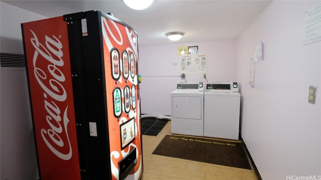 clothes washing area featuring hardwood / wood-style flooring and separate washer and dryer