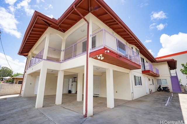 view of home's exterior with a balcony and water heater