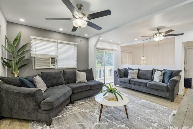 living room with ceiling fan and light hardwood / wood-style floors