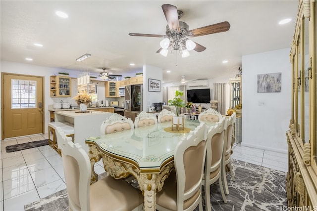 dining area with an AC wall unit and sink