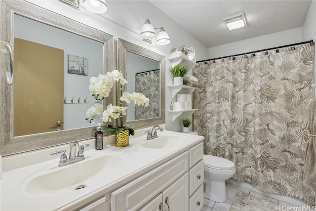 bathroom with vanity, a textured ceiling, and toilet