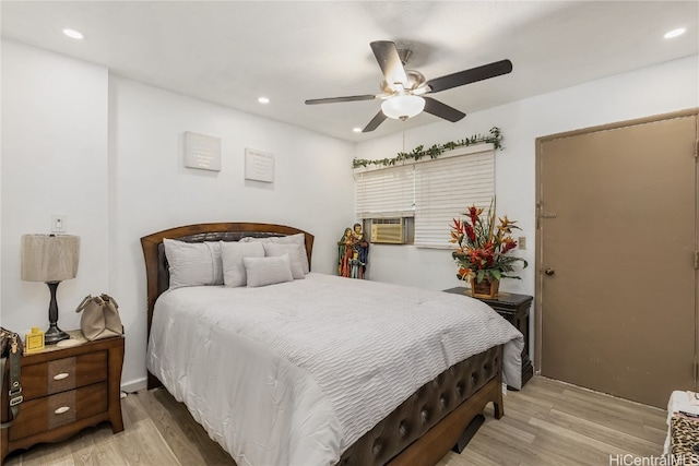 bedroom featuring cooling unit, ceiling fan, and light hardwood / wood-style floors