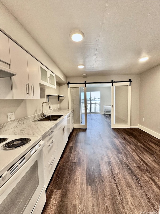 803 Waimanu St Unit 426, Honolulu, HI 96813 - kitchen with white electric range, a barn door, dark wood-style flooring, white cabinetry, and dishwasher